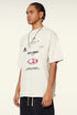 Side angle of model in cream tee with relaxed fit