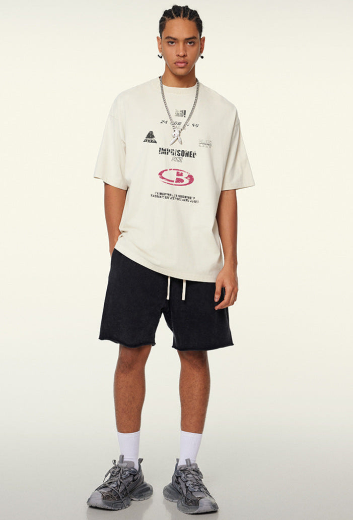 Model in cream t-shirt with black shorts and grey sneakers
