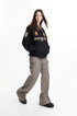 Three-quarter view of black work jacket showing contrast collar and sleeve crest
