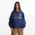 Front studio view of blue jacket with crest embroidery and flap pockets