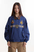 Close front view of blue embroidered jacket with brown contrast collar