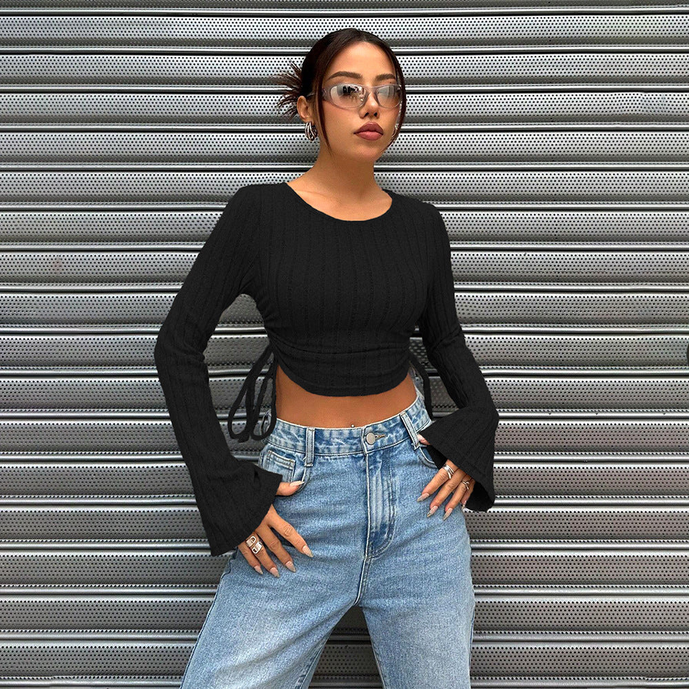 crop tops for women, black ribbed knit with bell sleeves, crew neck, hands-on-hips front view