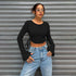 crop tops for women, black ribbed knit with bell sleeves, crew neck, hands-on-hips front view
