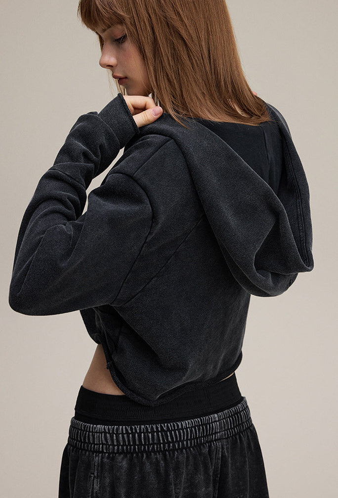 Black cropped hoodie, back view—short length, clean finish.