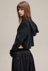 Black cropped hoodie, side view—drop shoulder and rib cuffs.