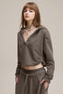 Brown cropped hoodie, side view—streetwear crop with raw hem.