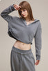 Light gray cropped hoodie, three-quarter view—short length streetwear crop.