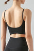 Black seamless tank top cropped with cami straps and sculpting fit.