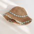 A breathable khaki straw hat with intricate blue floral embroidery along the brim, perfect for sun protection with a stylish touch.