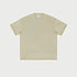 Beige oversized t-shirt displayed flat against light gray background with branded tag visible