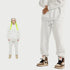 White sweatsuit showcased in split-view format with full outfit on left and close-up detail of jogger leg and brown/white Jordan sneakers on right against white background