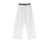 White wide-leg sweatpants with an elastic waistband and drawstring, displayed on a textured background.