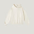 Cream-colored hoodie with kangaroo pocket and ribbed hem on light background