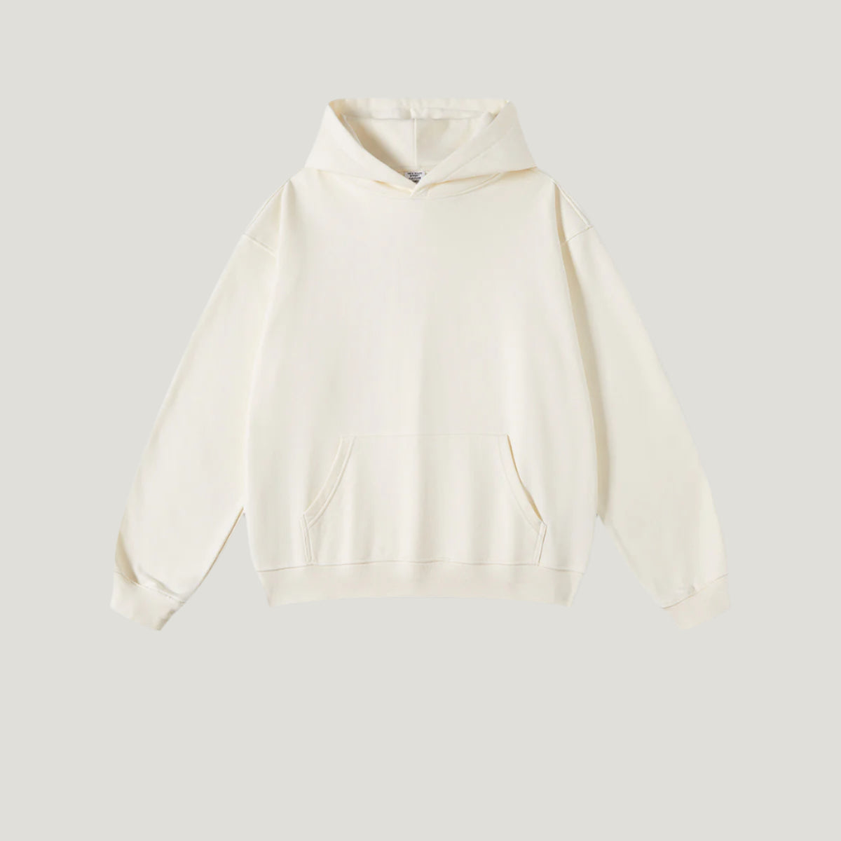 Cream-colored hoodie with kangaroo pocket and ribbed hem on light background