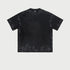 Black oversized t-shirt displayed flat showing washed effect and boxy silhouette against white background. Features crew neckline