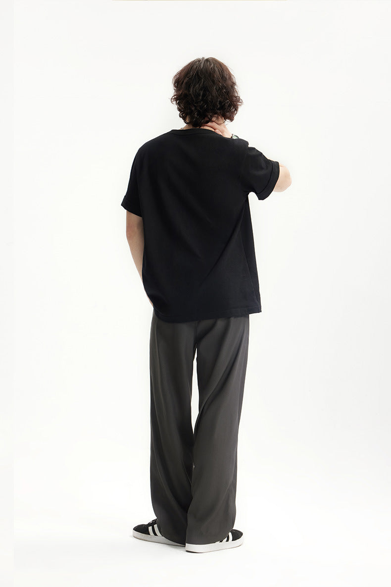 Back view of dark gray mens dress pants with black T-shirt outfit