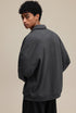 Dark gray polo zip up, back view with dropped shoulders