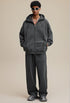 Dark gray zip hoodie, hands-in-pocket, oversized streetwear look