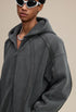 Close-up of sculpted seams and two-way zipper on dark gray hoodie