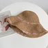  A foldable khaki straw hat featuring delicate pink floral embroidery, adding a soft, romantic charm to any summer outfit.