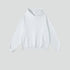 White cotton hoodie with front pocket and ribbed cuffs on light background