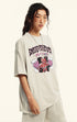 Angled side view of model in off-white "Deserve" devil tee.