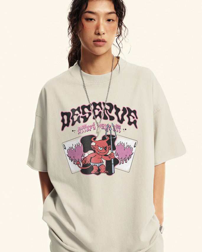 Close-up of model in off-white "Deserve" tee showing full chest graphic.