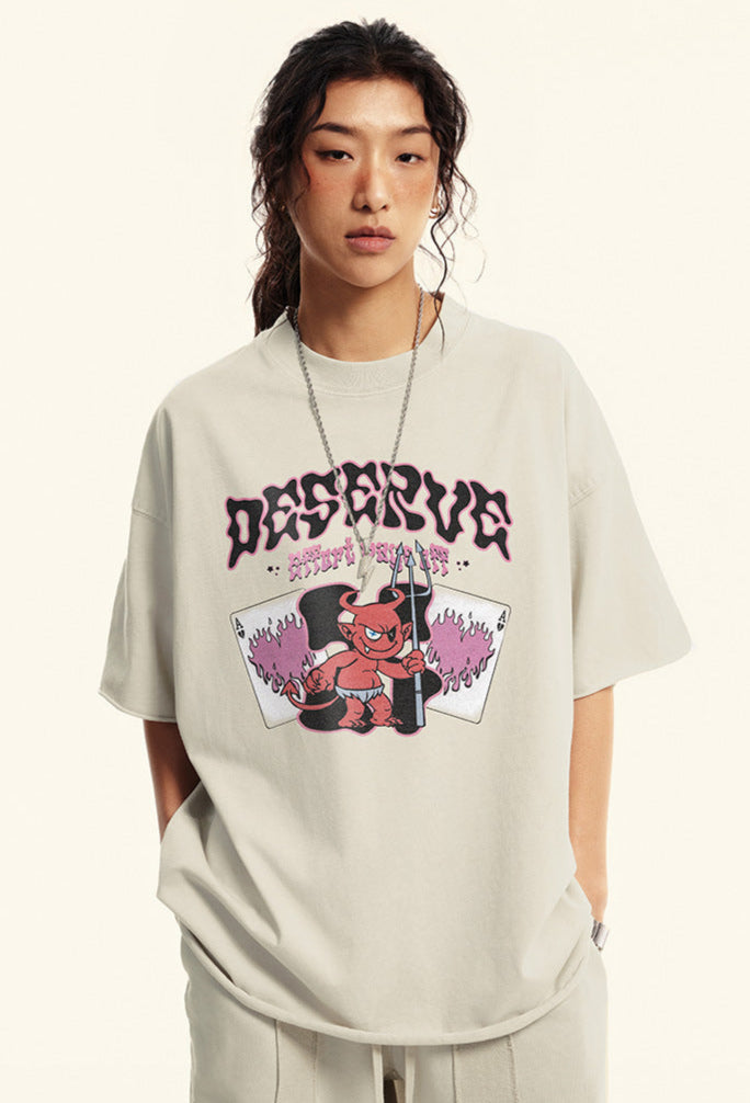 Close-up of model in off-white "Deserve" tee showing full chest graphic.