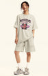 Model wears off-white "Deserve" devil tee with matching oversized shorts.