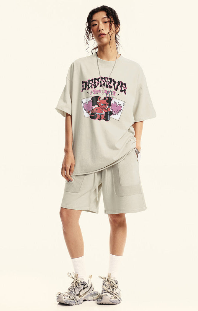 Model wears off-white "Deserve" devil tee with matching oversized shorts.