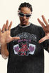 Close-up of model in black "Deserve" tee posing with hands up.