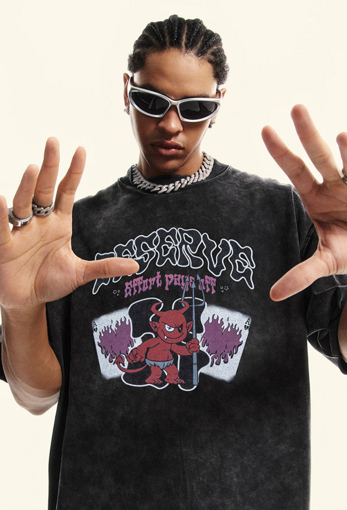 Close-up of model in black "Deserve" tee posing with hands up.