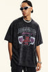 Man wears oversized black graphic tee with red devil and 'DESERVE' text.