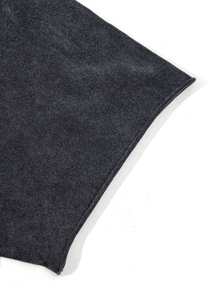 Close-up of black short sleeve hem on washed cotton T-shirt.