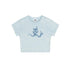 Flat lay of a light blue cropped t-shirt with a blue devil girl and snake graphic