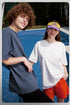Male and female models in oversized blue and white tees, streetwear vibe