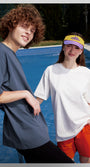 Male and female models in oversized blue and white tees, streetwear vibe