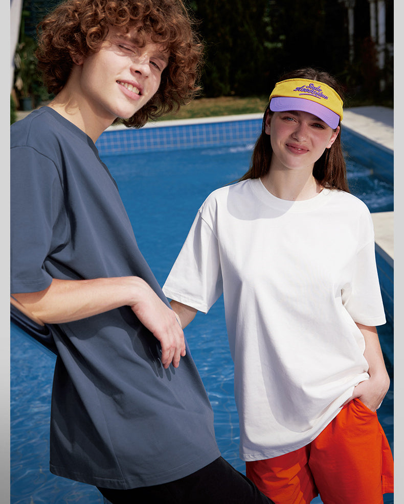 Male and female models in oversized blue and white tees, streetwear vibe