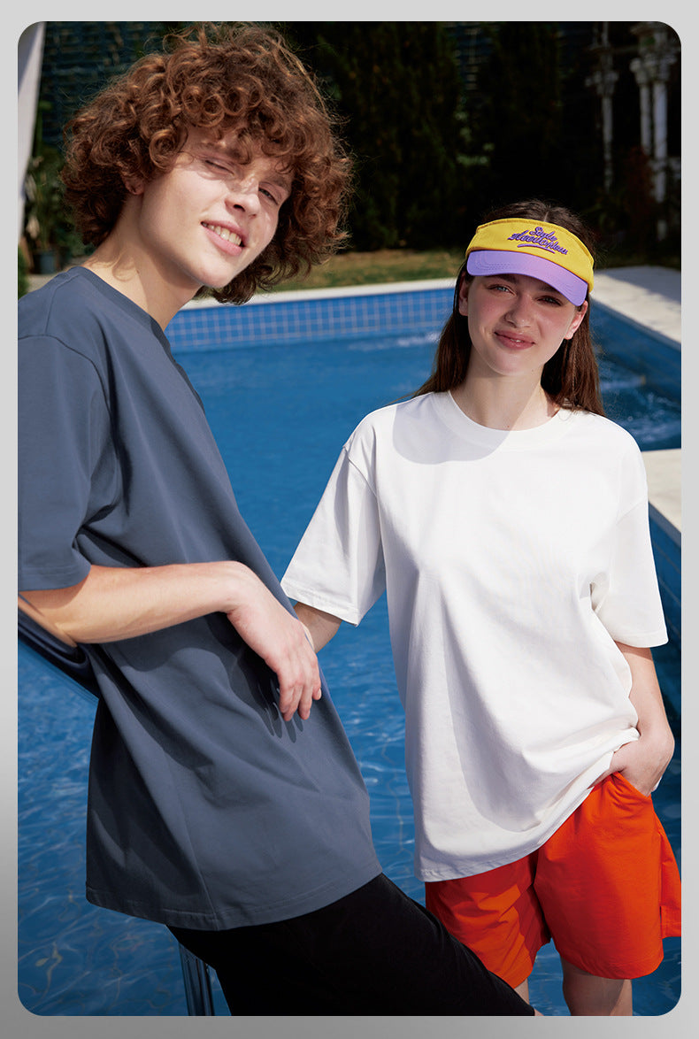Male and female models in oversized blue and white tees, streetwear vibe