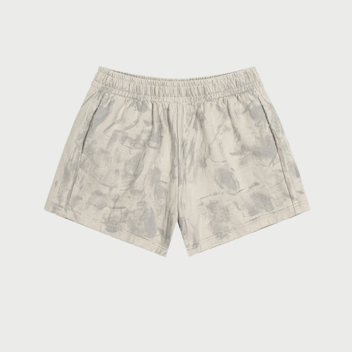 Cream colored shorts with elastic waistband and subtle pattern displayed flat against white background