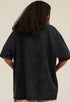 Back view of model wearing washed black angel T-shirt, plain back design visible.