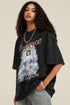Close-up of model wearing black angel tee with hand in pocket, showing necklace and bracelet details.