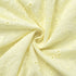Close-up of light yellow fabric with floral patterns