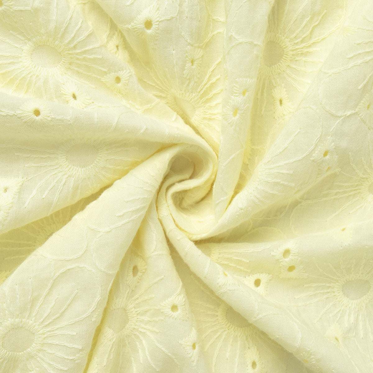 Close-up of light yellow fabric with floral patterns