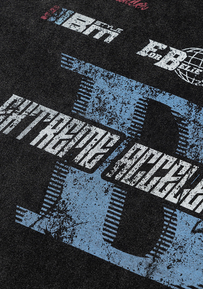 Angled detail of distressed graphic print on T-shirt front.