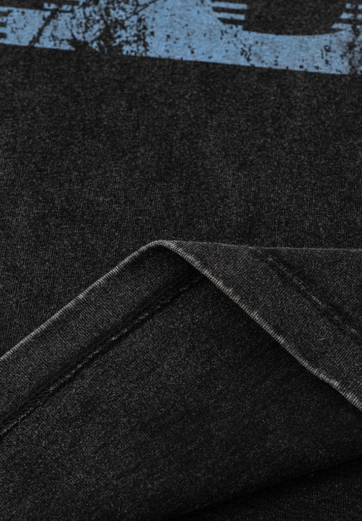 Folded edge of T-shirt fabric showing stitching.