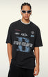 Man wears black graphic tee with 'Extreme Acceleration' lettering.