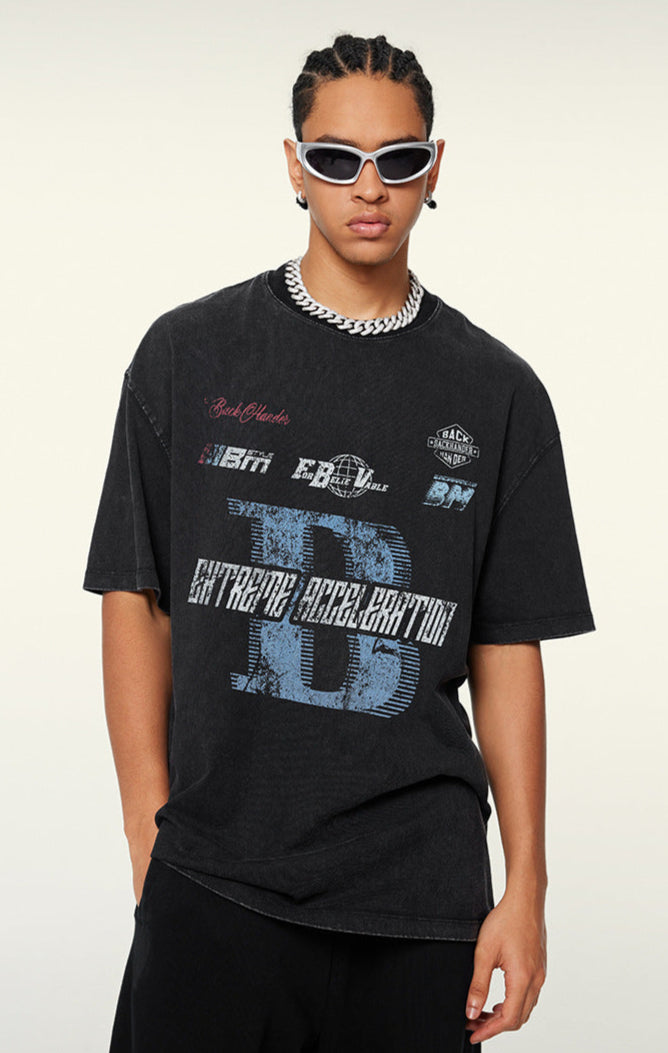 Man wears black graphic tee with 'Extreme Acceleration' lettering.