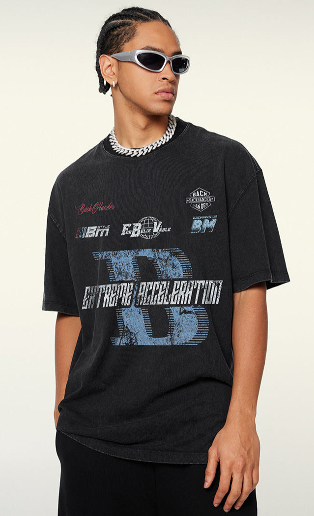 Side view of model in oversized black graphic tee with bold text.