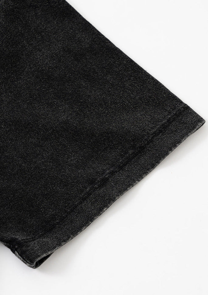 Hem detail of black T-shirt sleeve.